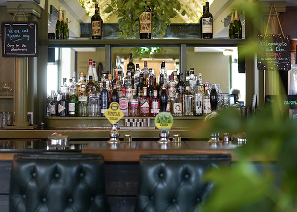 A well-stocked Stamford pub bar with real ale pumps and leather seating